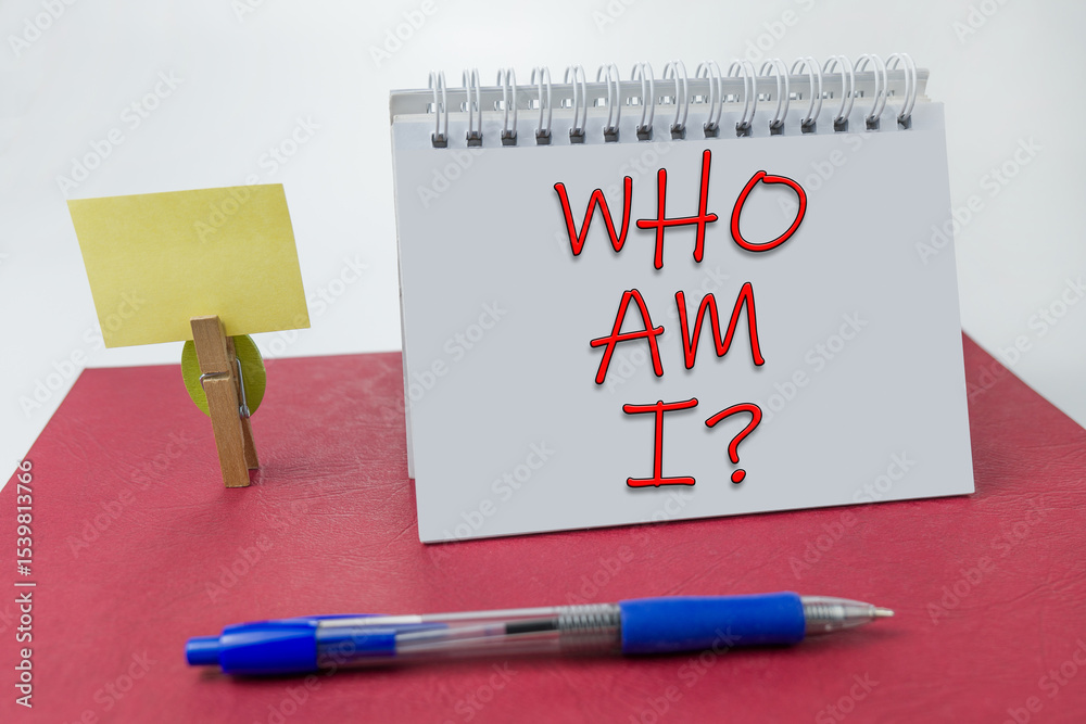 Who Am I written on a notebook on a red background