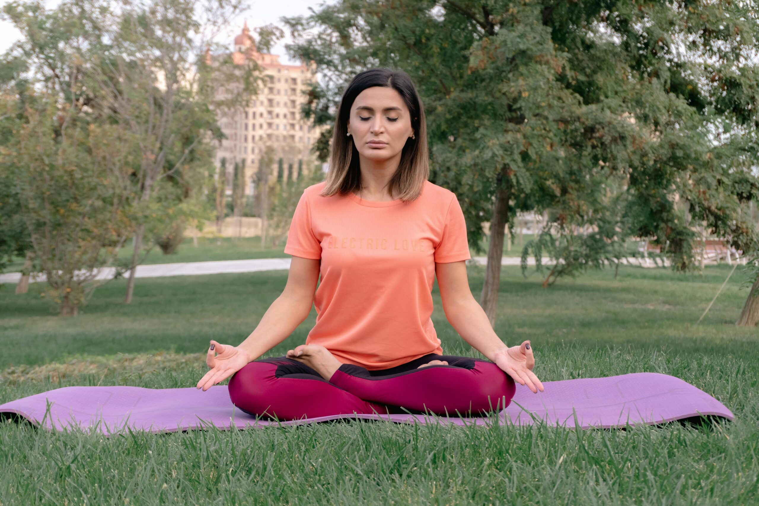 Woman practicing yoga outdoors in a park